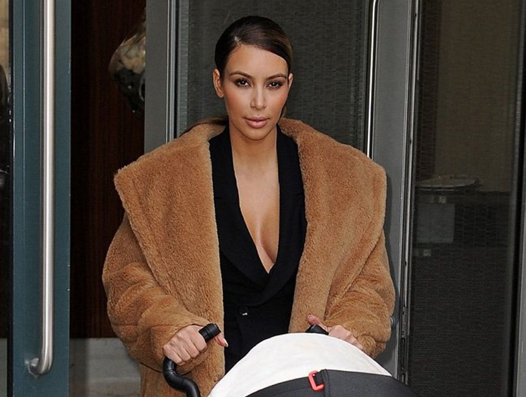 Smiling mom Kim Kardashian walks out with baby North whom she wants to walk down the isle with her stepfather Bruce Jenner. Smiling mom Kim Kardashian walks out with baby North whom she wants to walk down the isle with her stepfather Bruce Jenner.
